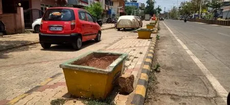 The condition of flowerpots lining the road is bad