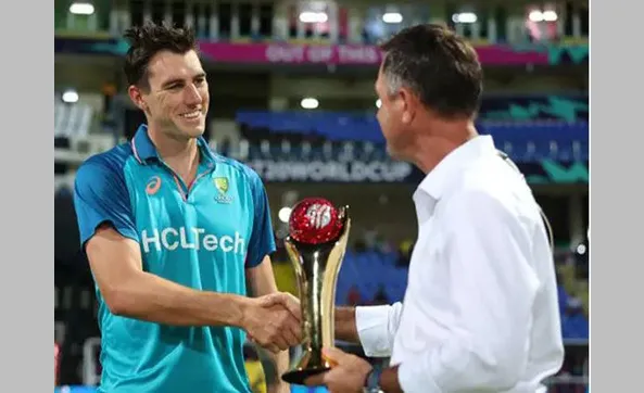 Cummins is presented with the cup by Ponting