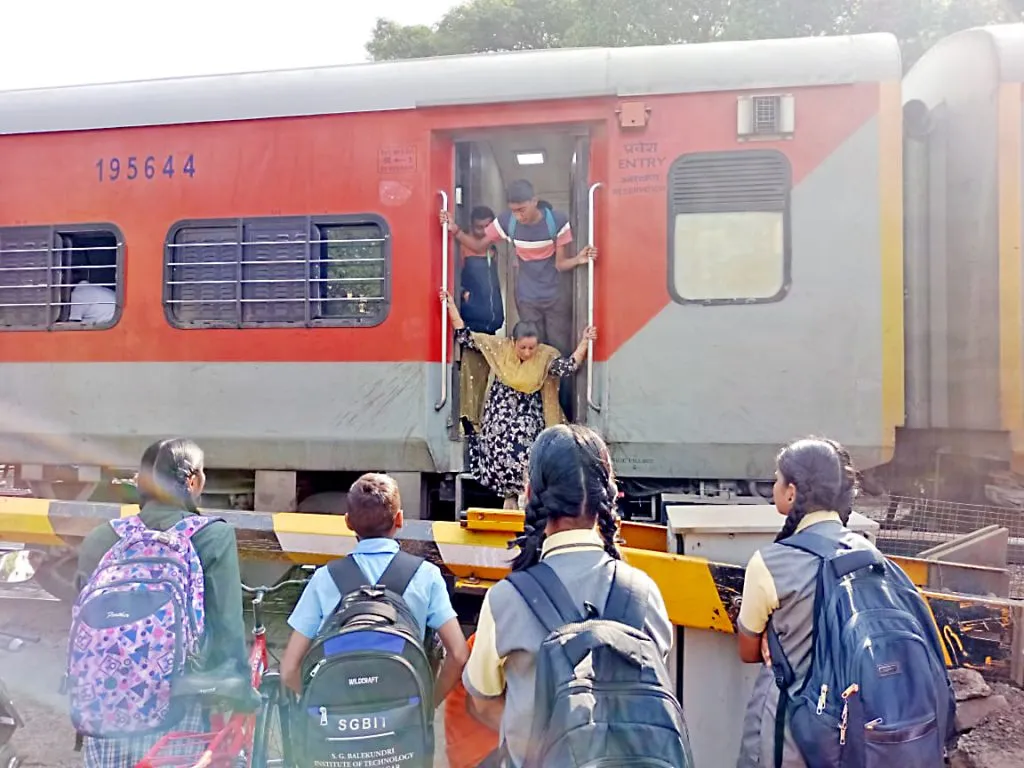 'School' of students and parents at railway gate