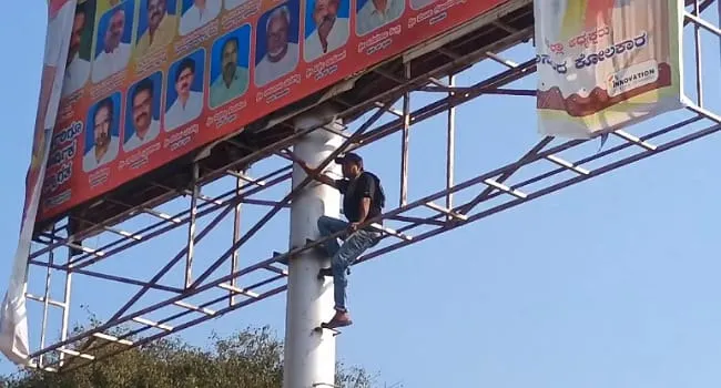 Suicide attempt by climbing a billboard pole