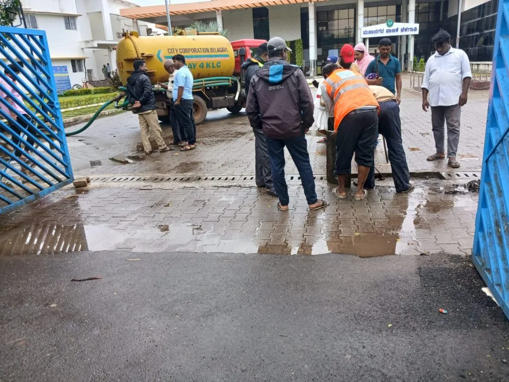 Rainwater forms a pond at the entrance to the municipal corporation