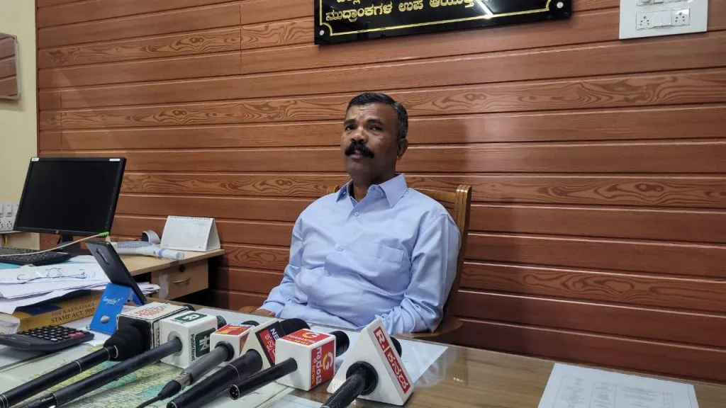 A clerk's son sits on the sub-registration officer's chair.