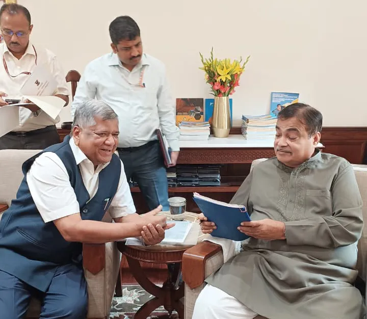 Give the status of National Highways to three state roads in Belgaum district