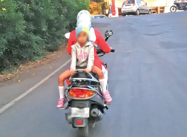 "A deadly ride with a pillion rider sitting facing the wrong direction on a two-wheeler