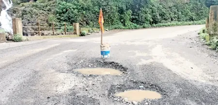 A flag planted in the potholes of Ambenali Ghat