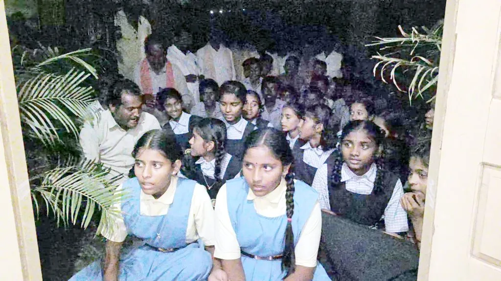 A group of students from Itagi sat in front of the Education Officer's office.